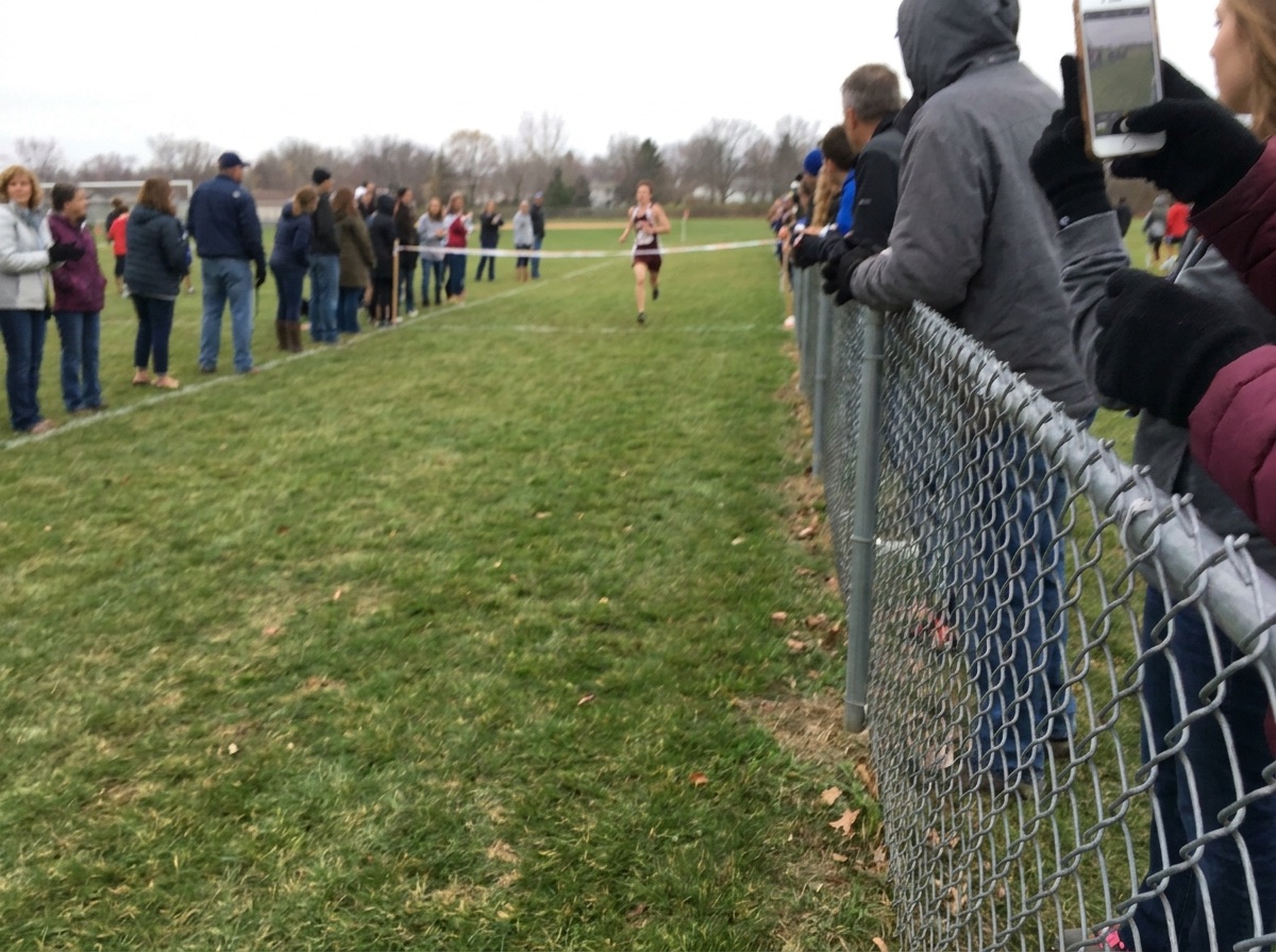 Local cross country runner approaching a finish line