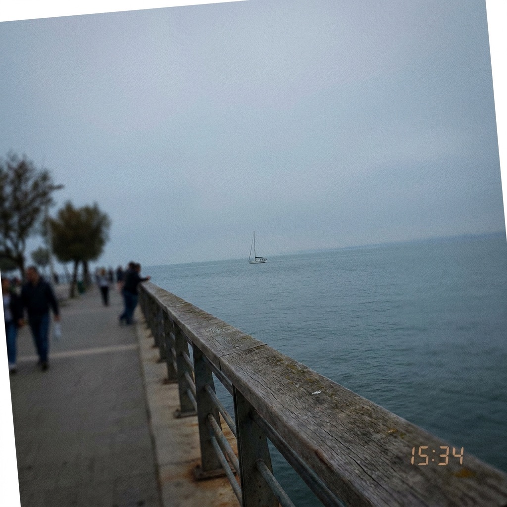 Small sailboat far out on the water from a waterfront promenade